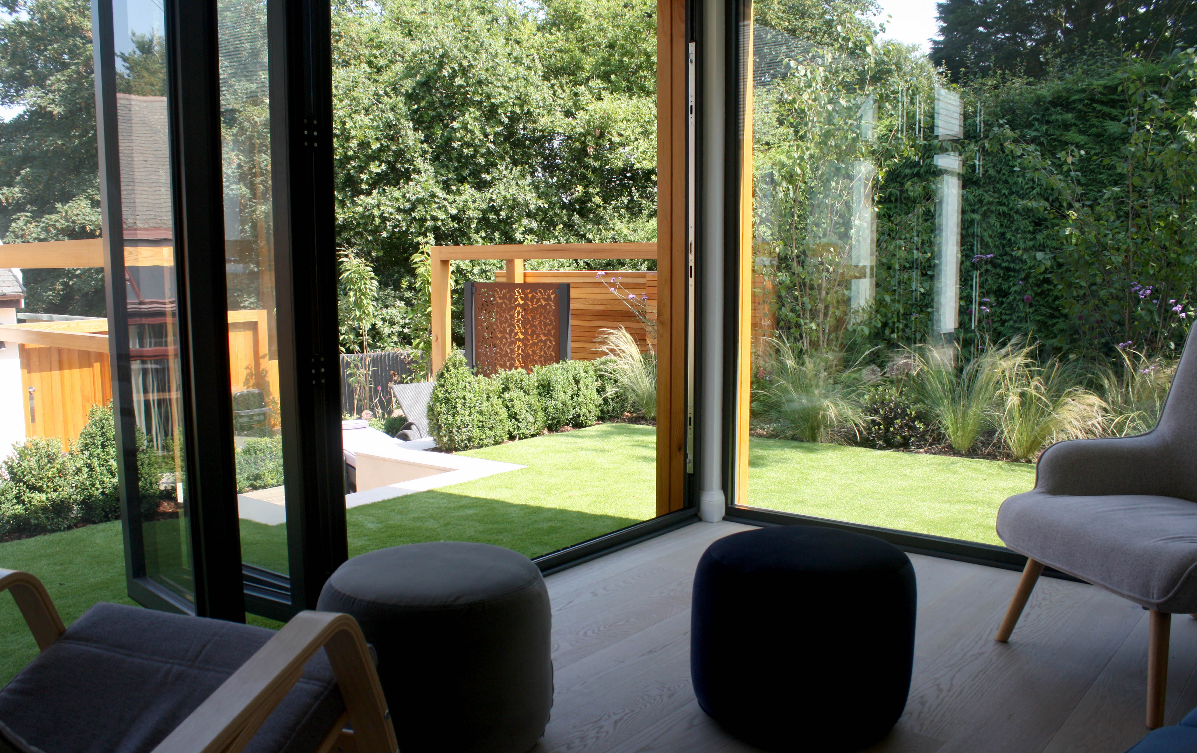 view out of summerhouse into the green modern garden
